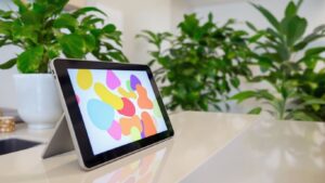 Modern clinic reception with tablet and plants.