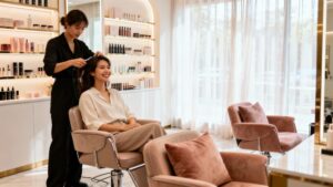 Beauty salon interior with happy customer and stylist.
